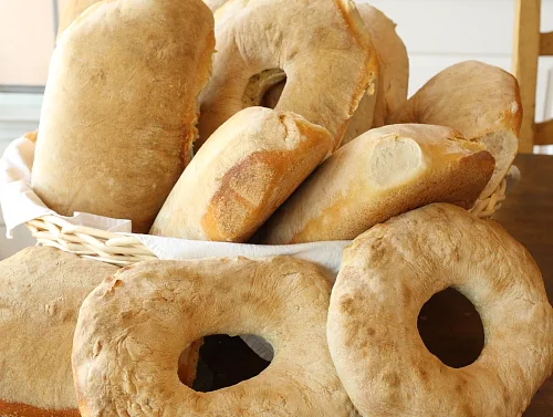Reference photograph of a basket of rustic Calabrese loaves.